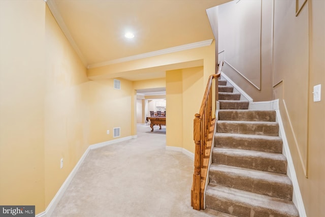 stairway with carpet, baseboards, visible vents, and ornamental molding