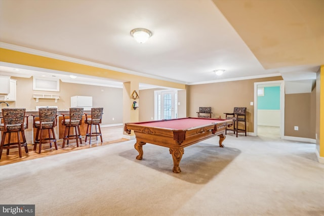 recreation room featuring baseboards, light colored carpet, pool table, crown molding, and bar area