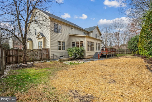 rear view of property with a yard, a fenced backyard, and a wooden deck