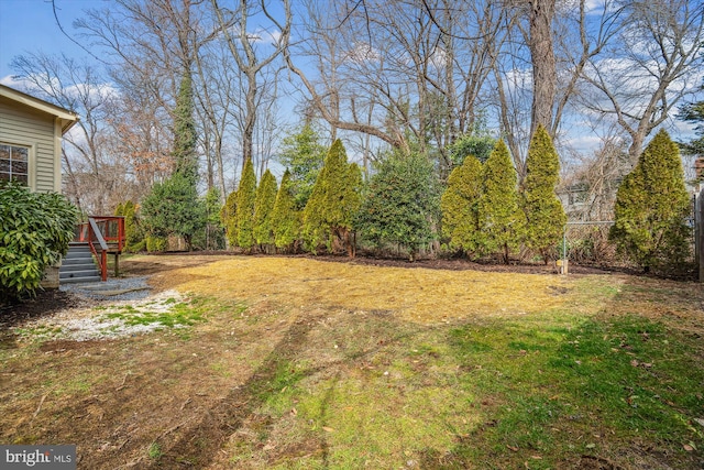 view of yard with fence and a deck