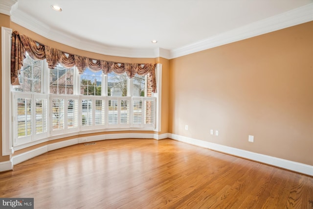 empty room with baseboards, recessed lighting, light wood-style flooring, and crown molding