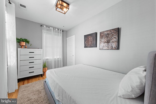 bedroom featuring light wood-type flooring and visible vents