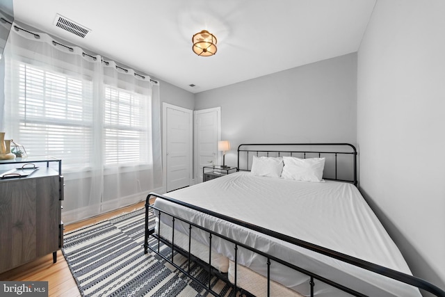 bedroom with visible vents and light wood finished floors