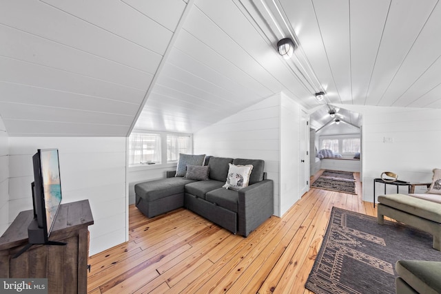 living room featuring lofted ceiling, plenty of natural light, wooden ceiling, and light wood-style flooring