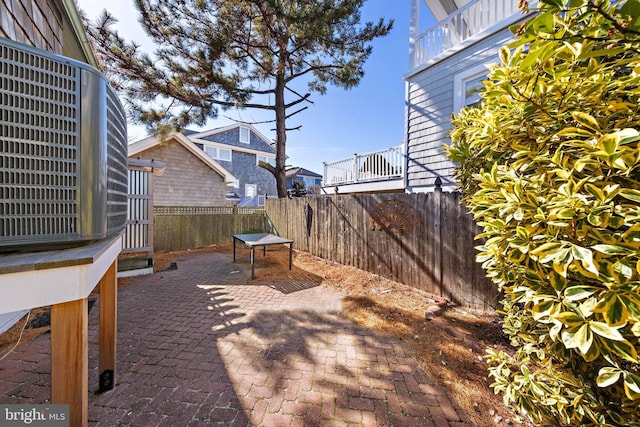 view of patio / terrace with cooling unit and a fenced backyard