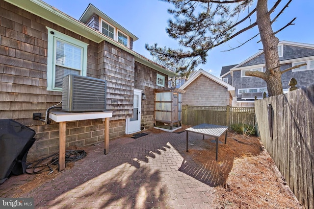 view of patio / terrace with central AC and a fenced backyard