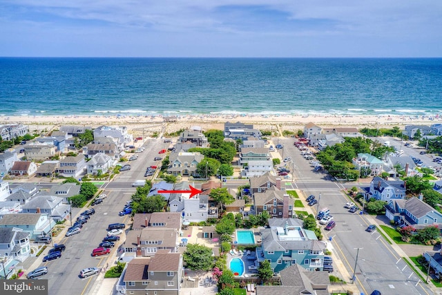 birds eye view of property with a beach view, a water view, and a residential view