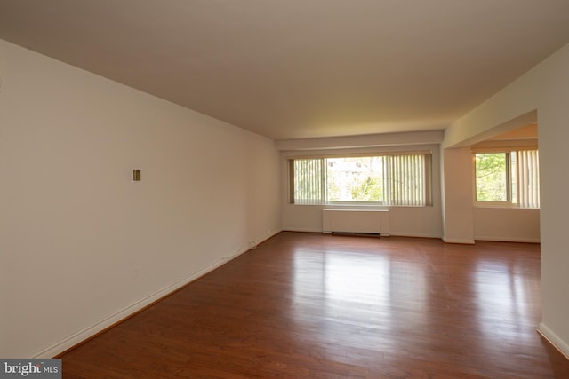 empty room with wood finished floors and baseboards