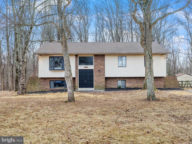 raised ranch with brick siding and roof with shingles