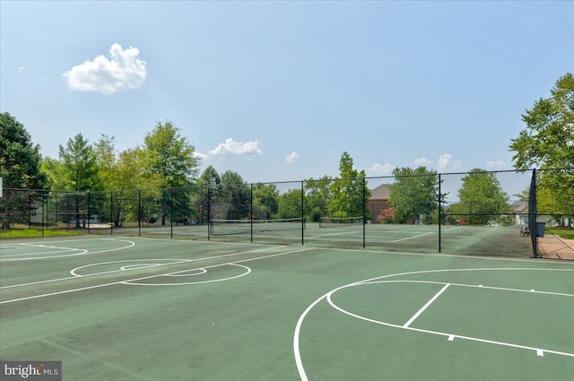 view of sport court with a tennis court, community basketball court, and fence