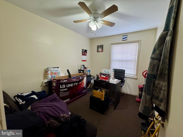 carpeted home office featuring baseboards and a ceiling fan