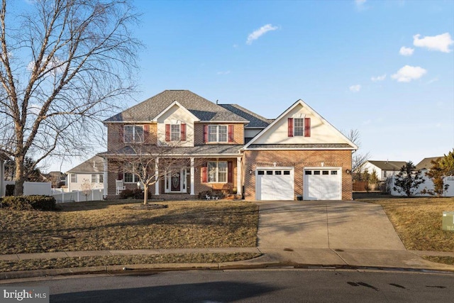 view of front of property featuring driveway, fence, a front lawn, and brick siding