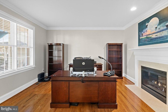 office space featuring a fireplace with flush hearth, light wood-style flooring, and baseboards