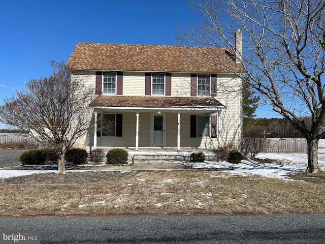 view of front of home with a shingled roof, a chimney, fence, and a porch