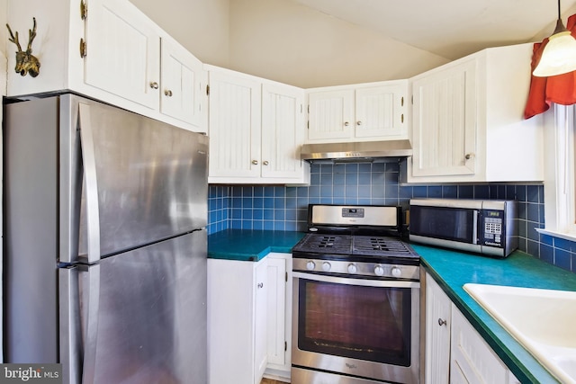 kitchen with under cabinet range hood, appliances with stainless steel finishes, and white cabinets