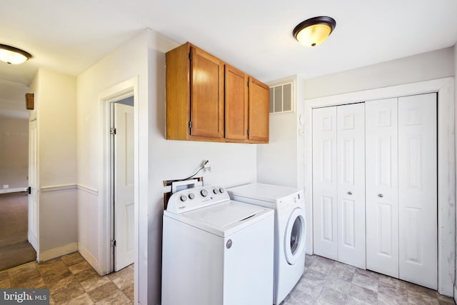 washroom with cabinet space, baseboards, visible vents, independent washer and dryer, and stone finish flooring