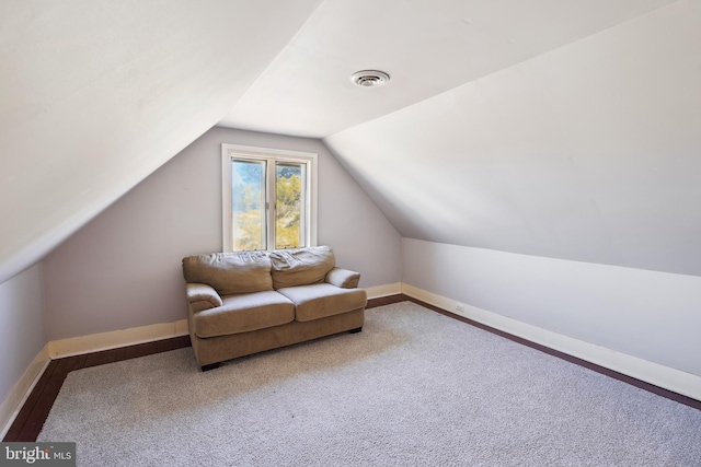 additional living space with visible vents, vaulted ceiling, and baseboards