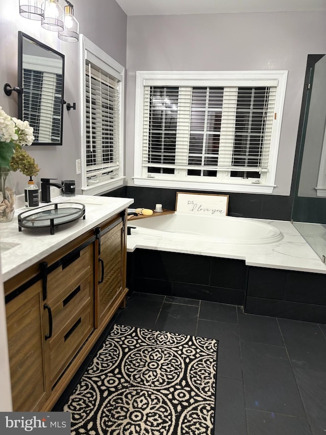 bathroom featuring vanity, tile patterned floors, and a bathing tub