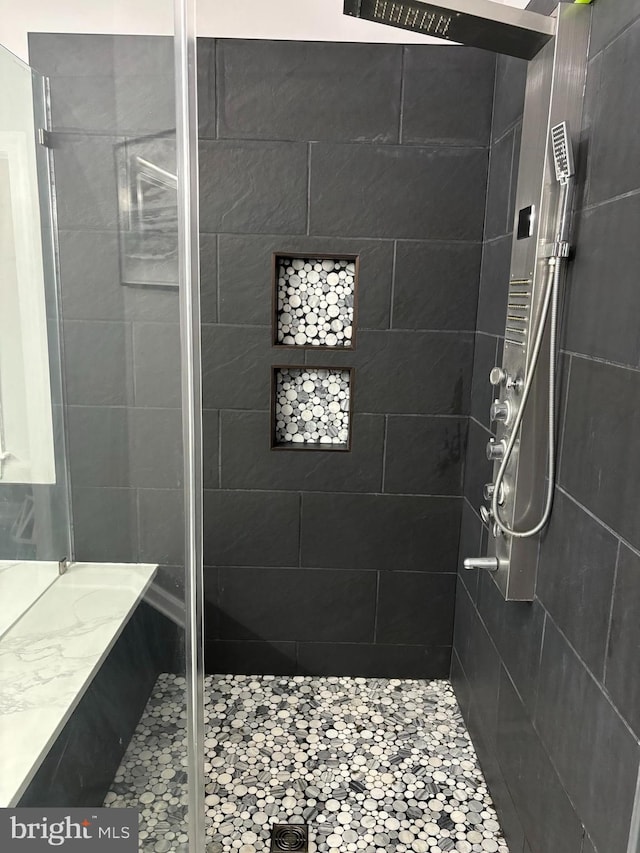 full bathroom with tiled shower