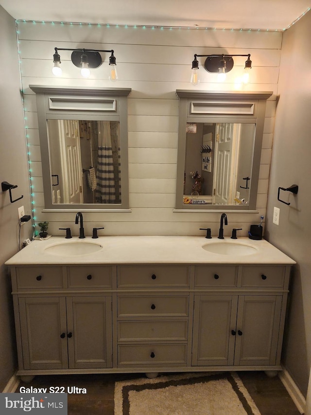 full bath featuring double vanity and a sink