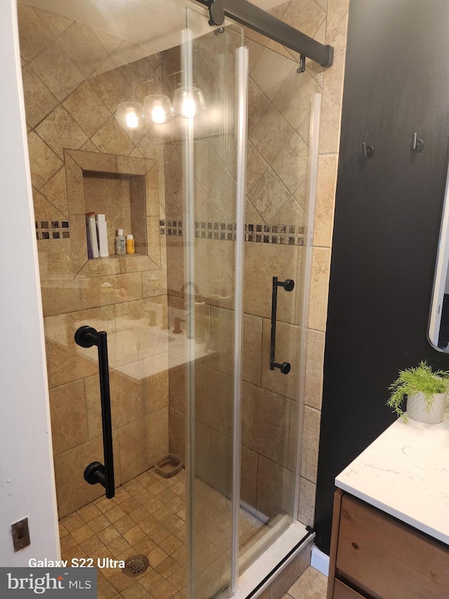 full bathroom featuring a stall shower and vanity