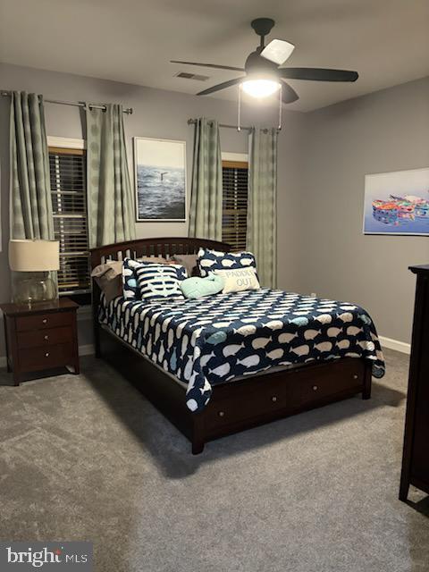 bedroom with visible vents, baseboards, a ceiling fan, and carpet flooring