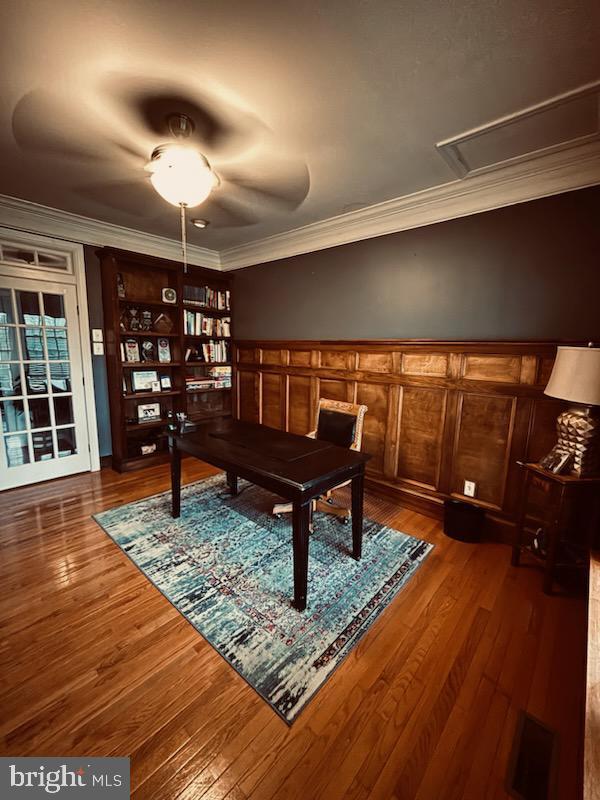 rec room with hardwood / wood-style floors and ornamental molding