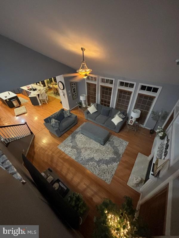 living room with stairway and wood finished floors