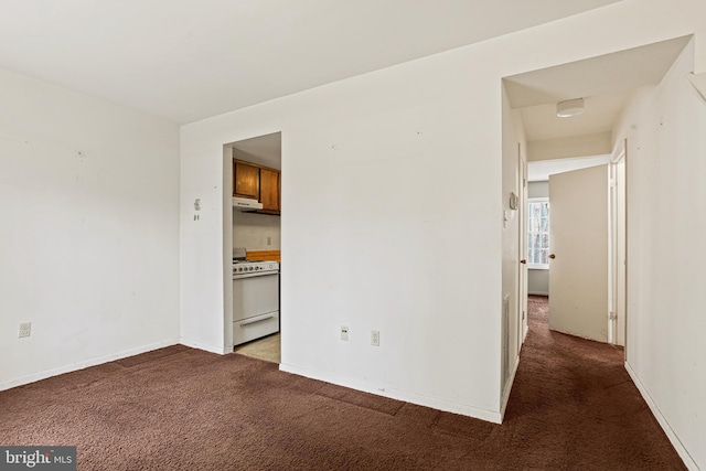 unfurnished room with carpet flooring and baseboards