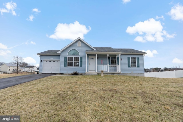 ranch-style house with covered porch, a garage, fence, driveway, and a front lawn