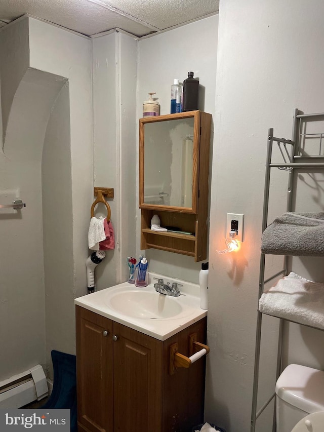 bathroom featuring toilet, a baseboard radiator, and vanity