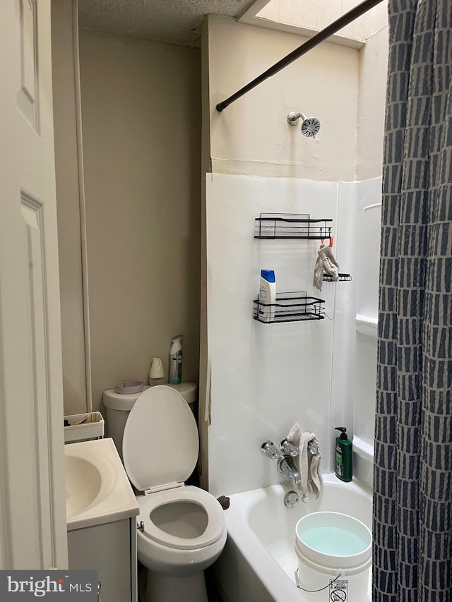 bathroom featuring shower / bath combination, toilet, a textured ceiling, and vanity