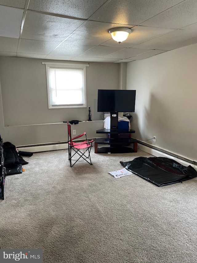 interior space featuring a baseboard heating unit and a paneled ceiling