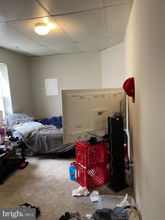 carpeted bedroom with a drop ceiling