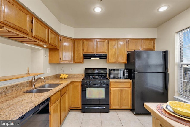 kitchen with black appliances, under cabinet range hood, a sink, and recessed lighting