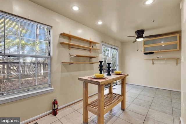 interior space with recessed lighting, ceiling fan, baseboards, and light tile patterned floors