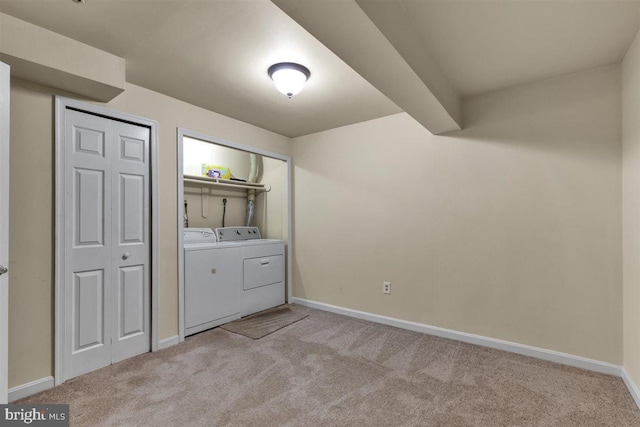 laundry area with baseboards, laundry area, light colored carpet, and washer and dryer