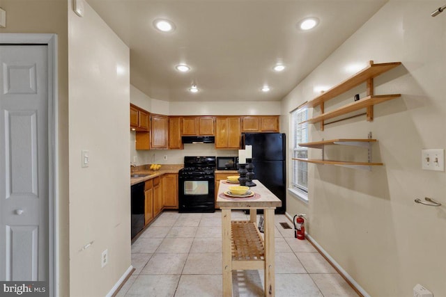 kitchen with brown cabinets, light tile patterned floors, recessed lighting, black appliances, and exhaust hood