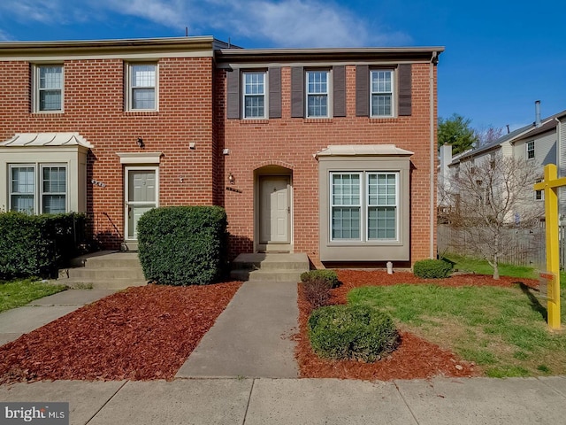 view of property featuring brick siding