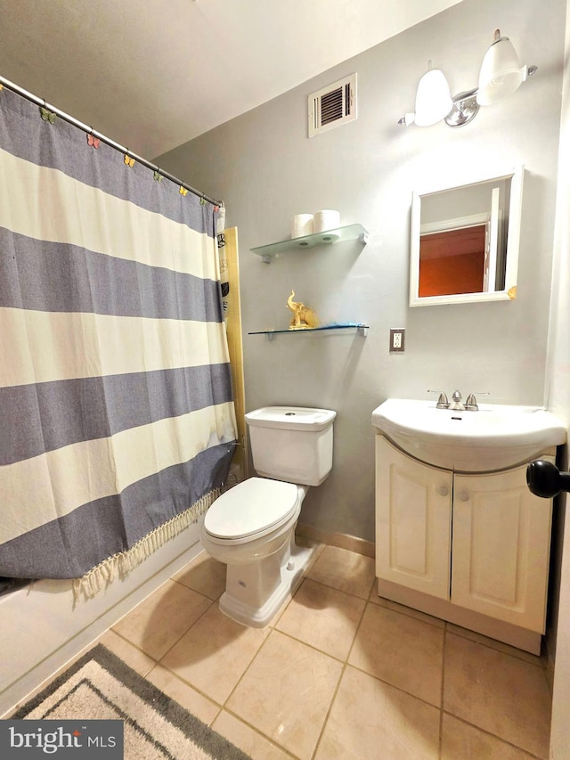 bathroom with visible vents, toilet, vanity, tile patterned flooring, and baseboards