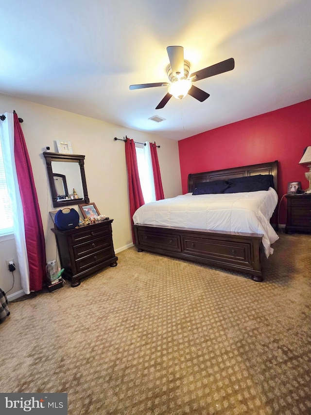 bedroom with light carpet, baseboards, visible vents, and a ceiling fan