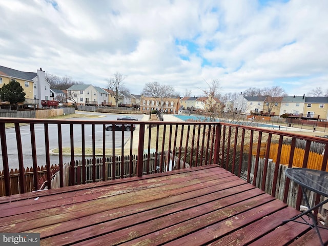 wooden terrace featuring fence and a residential view