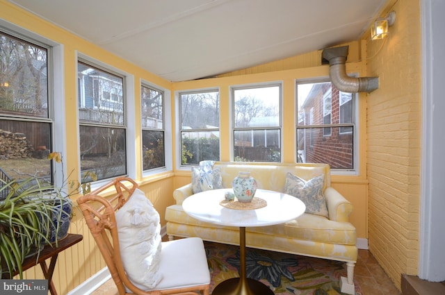 sunroom / solarium featuring lofted ceiling