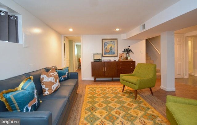 living area with baseboards, visible vents, wood finished floors, stairs, and recessed lighting