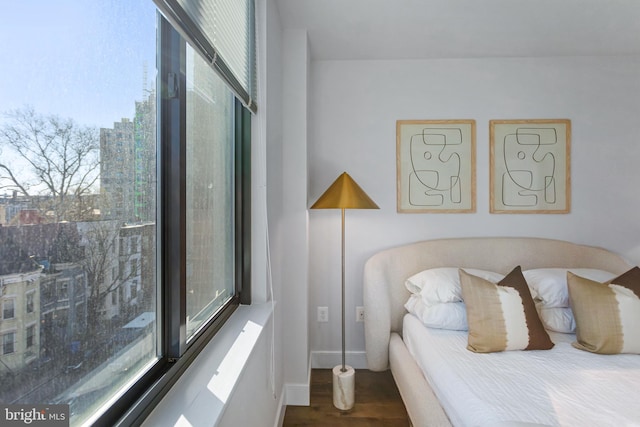 bedroom featuring baseboards and wood finished floors