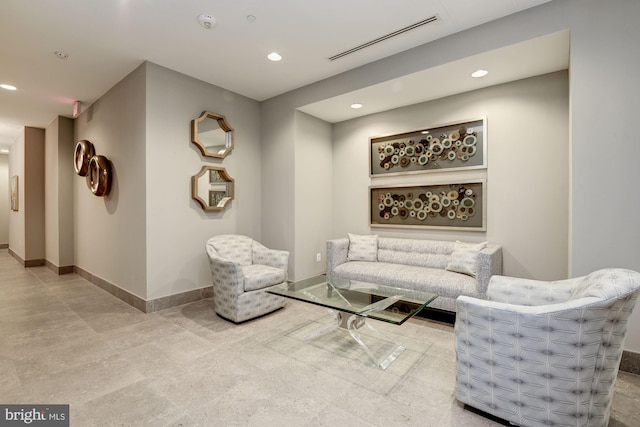 living room with recessed lighting, visible vents, and baseboards