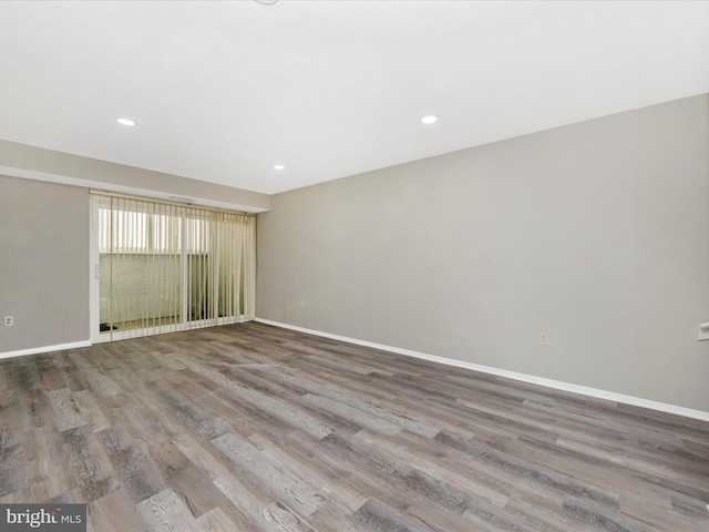 spare room with light wood-style floors, recessed lighting, and baseboards