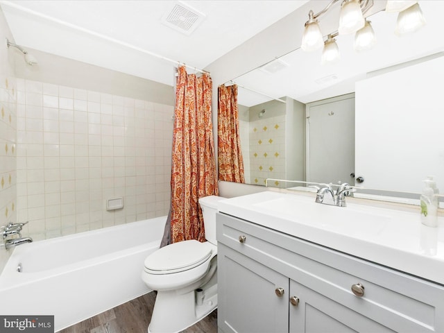 bathroom with visible vents, toilet, wood finished floors, shower / bath combination with curtain, and vanity