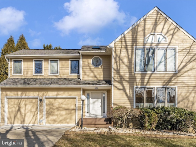 view of front of home featuring concrete driveway and an attached garage