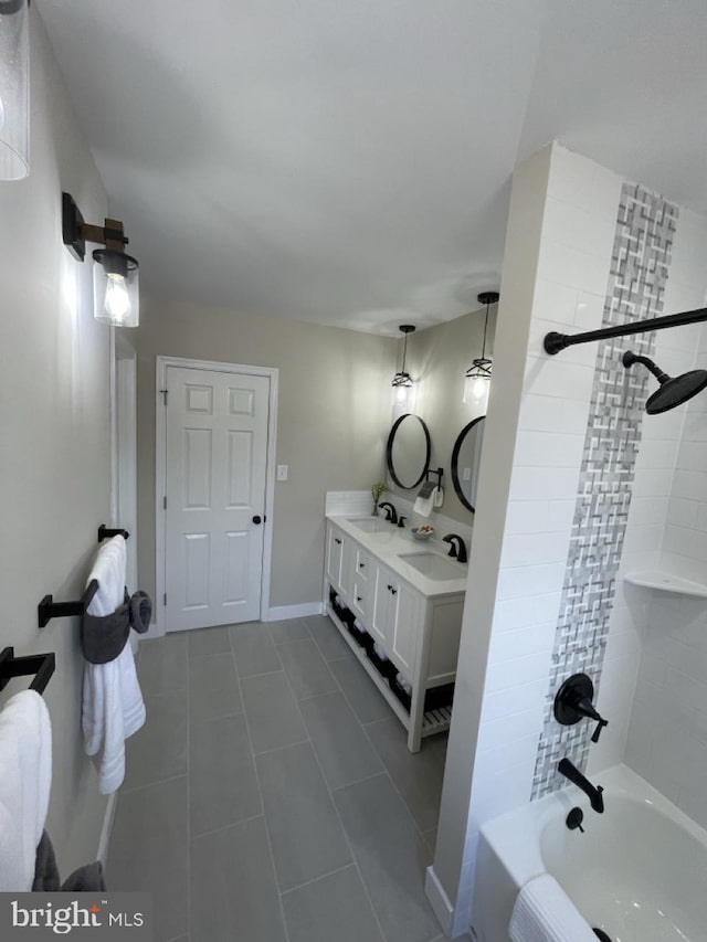 full bathroom with double vanity, baseboards, a sink, and shower / bathing tub combination